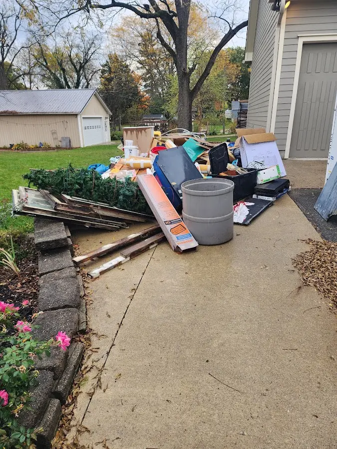 Dumpster being loaded with debris for 12 Yard Dumpster Rental in Thatcher